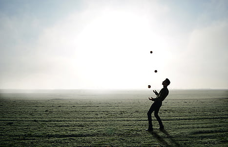 man juggling on clear field