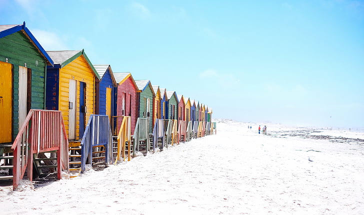 assorted-colored wooden cottages on seashore