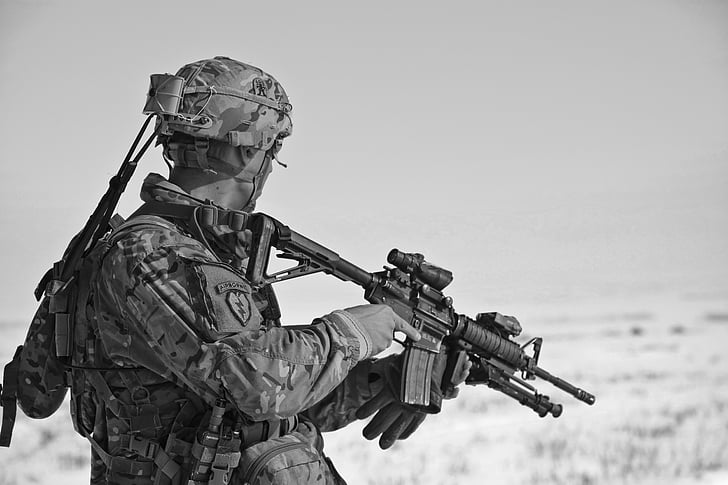 grayscale photo of a soldier holding sniper rifle