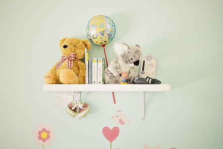 bear and kuala plush toys on white wooden floating shelf