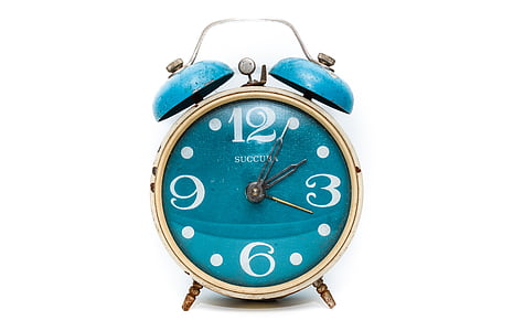 round brass-colored and blue alarm clock