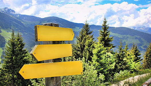 yellow wooden arrow signage