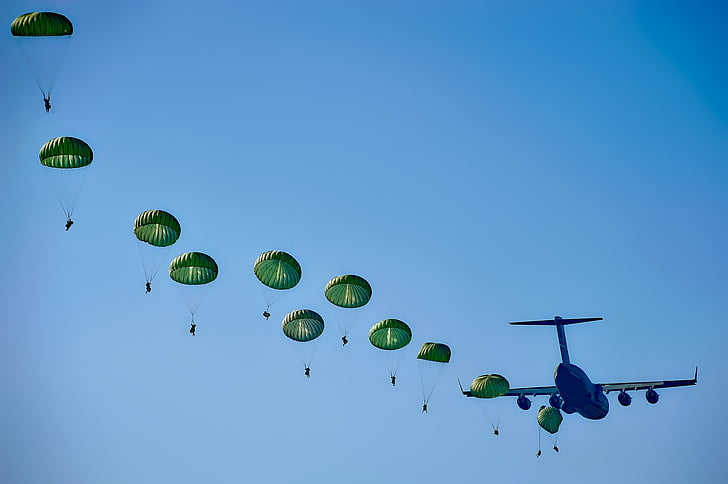 blue airplane and green parachutes
