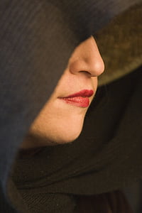woman's red lips wearing black cloak