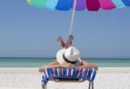 person lying down on beach chair