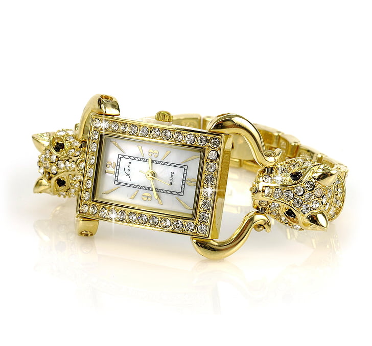 rectangular gold-colored analog watch with clear gemstone