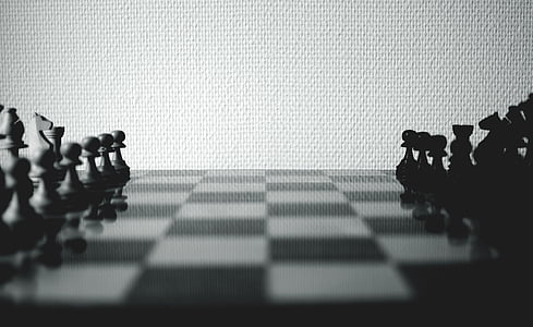 greyscale photo of chessboard with arranged piece
