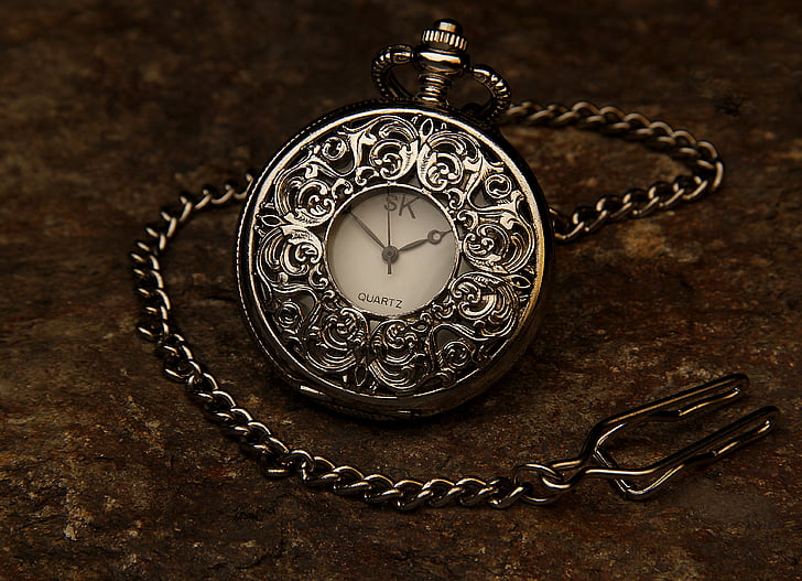 silver-colored pocket watch with link strap