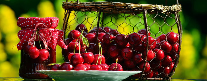 photo of red cherries with basket and plate