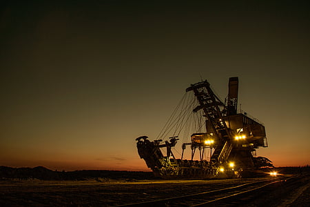 brown heavy machinery with lights during golden hour