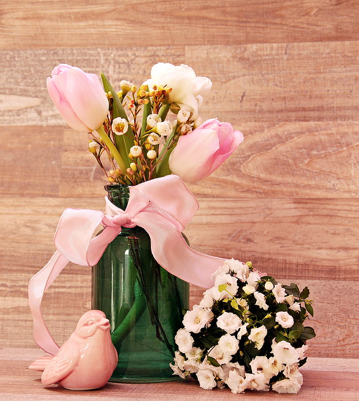 pink flowers in green glass vase