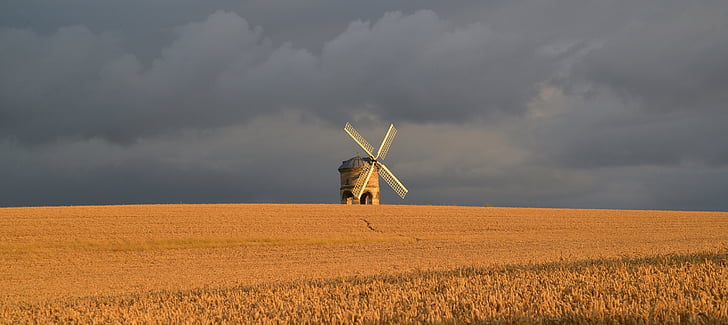white wind mill on grass field