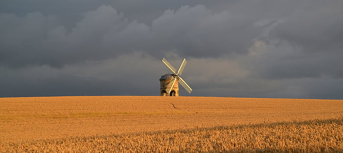 white wind mill on grass field