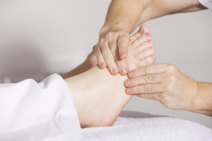 person massaging another person's right foot