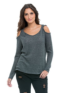 woman in gray cold-shoulder long-sleeved shirt and black jeans