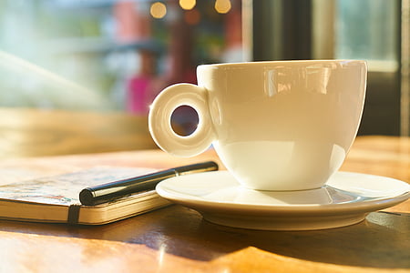 white ceramic coffee mug on table