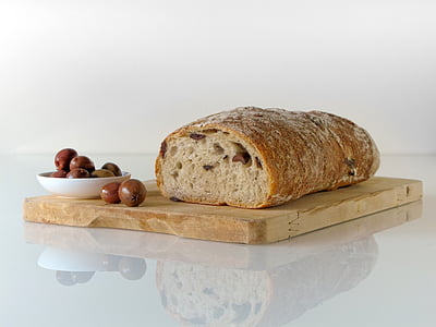 glazed bread on brown wooden chopping board
