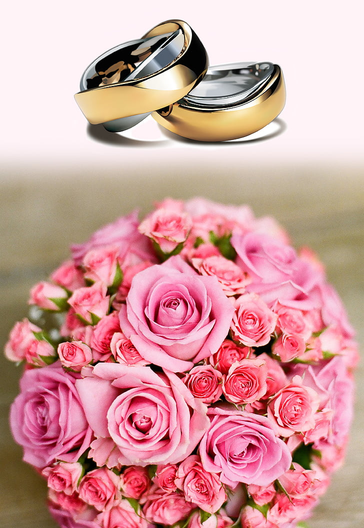 two gold-colored wedding ring and bouquet of rose