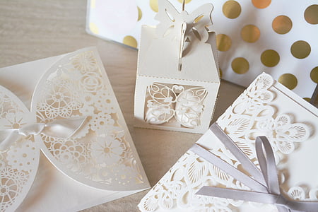 two white floral inviation cards