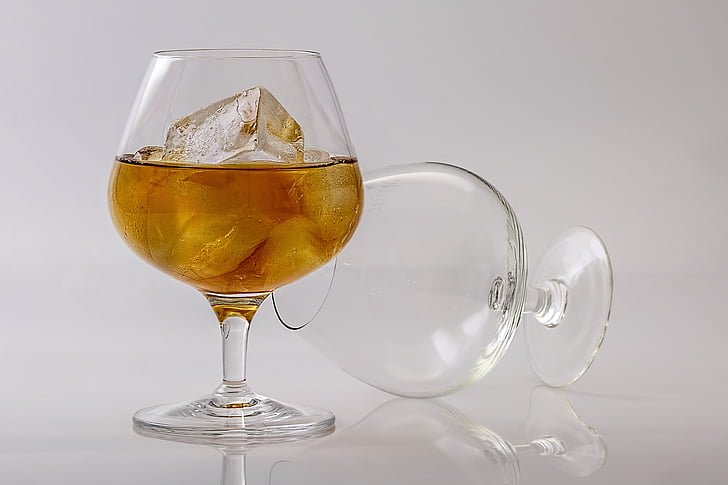 clear wine glass with half-filled with liquor and ice
