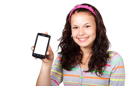 woman holding black smartphone while smiling