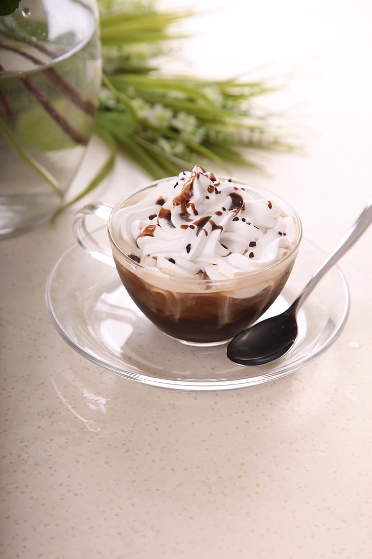 clear glass cup filled with coffee with cream