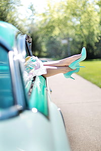 selective focus photograph of person wearing teal pump-heeled shoes