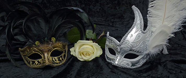 photo of gold and silver mask beside white rose flower