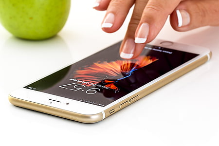 person touching gold iPhone 6