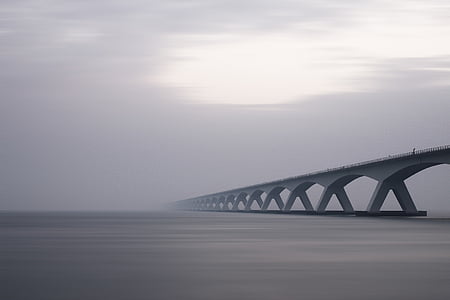 gray bridge on body of water