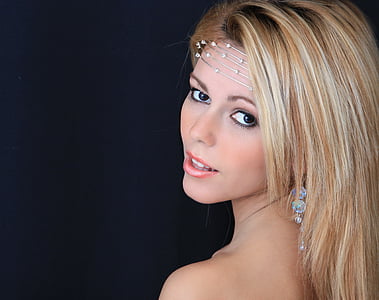 woman with blonde hair wearing silver-colored accessories