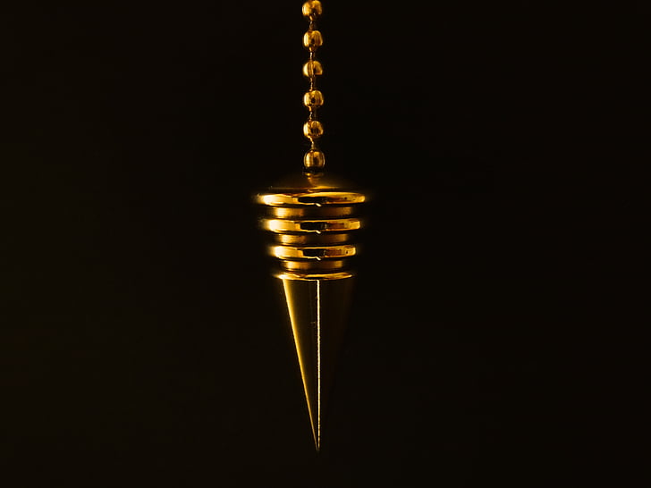 macro photography of gold pendant