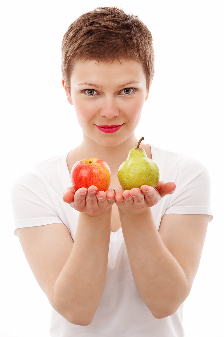 woman holding apple and pear fuits