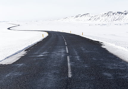 winding road near snow field