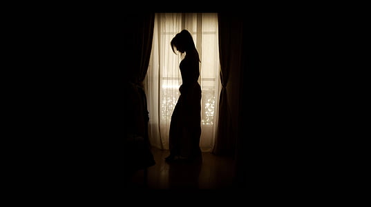 woman standing near window