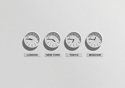 four round white analog wall clocks