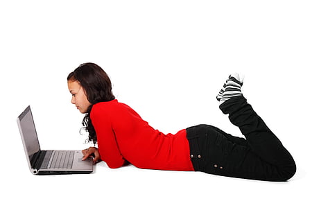 woman laying in front of laptop computer