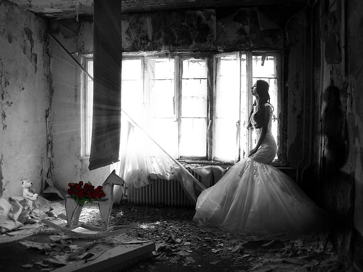 woman in white dress inside dark messy room