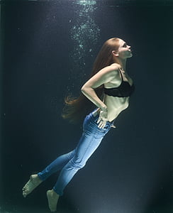 woman on water wearing jeans and bra