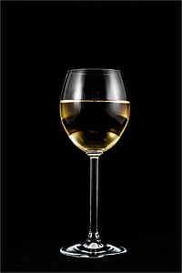 photograph of glass of white on black background