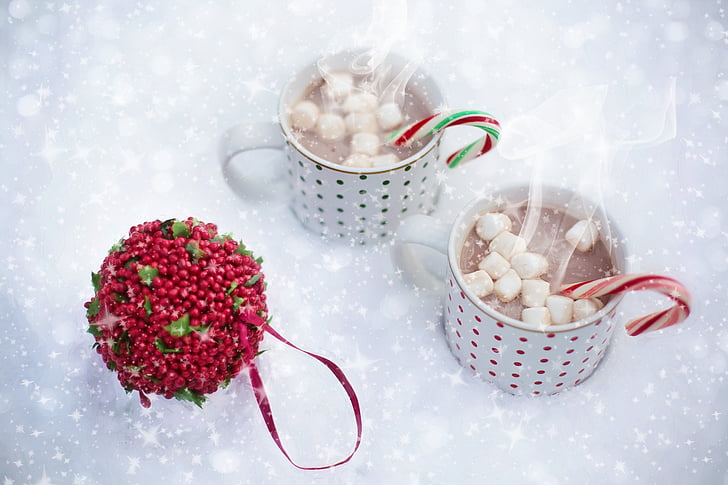two white ceramic mugs with filled with white marshmallows