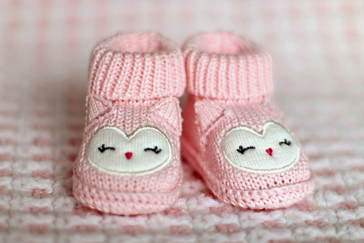 shallow focus photography of pair of baby's pink knitted shoes