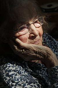 woman wearing eyeglasses looking down