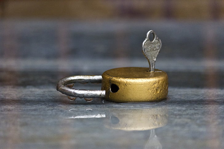 gold padlock with key photograph