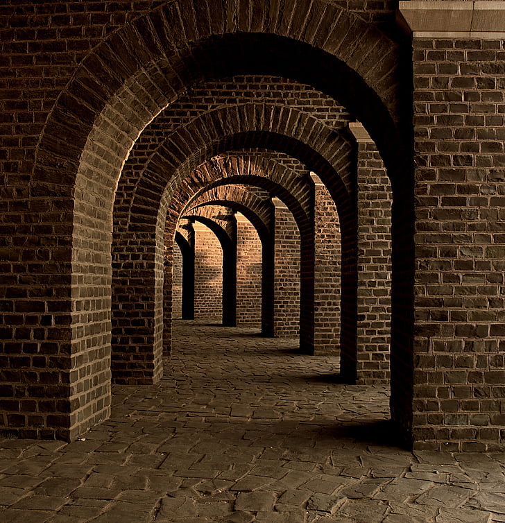photo of gray brick hallway