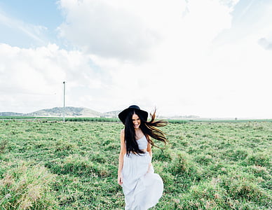black haired woman in white dress during day time
