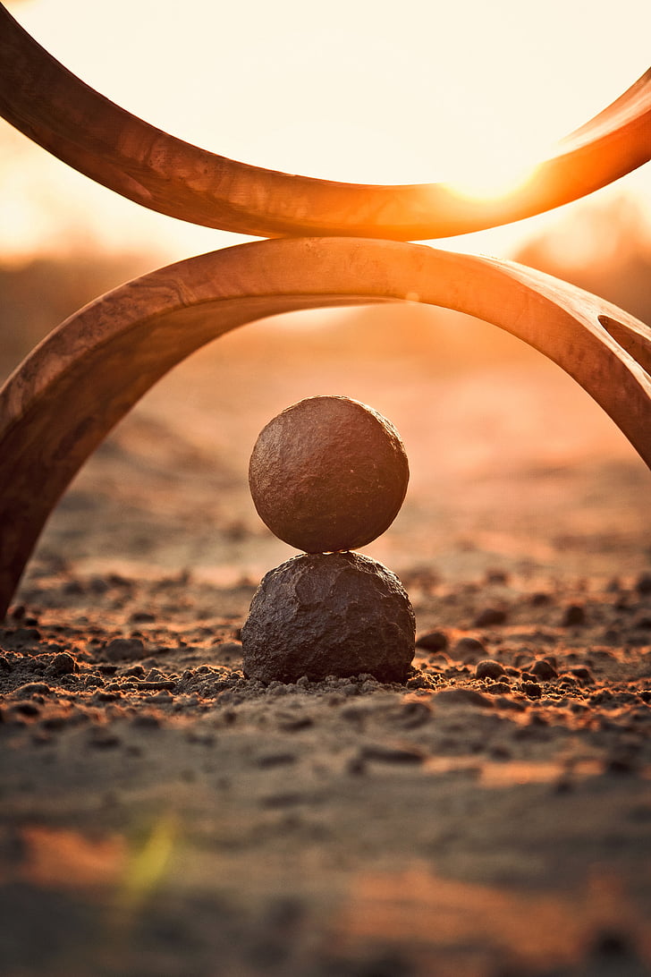 round stone and view of sunset