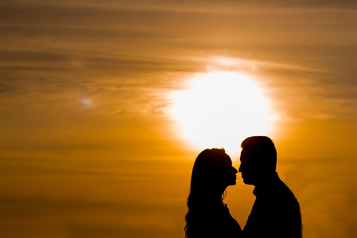 silhouette of man and woman facing each other