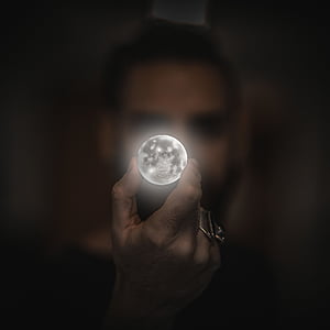 person holding moon artwork