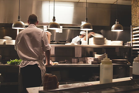man in chef uniform standing near counter